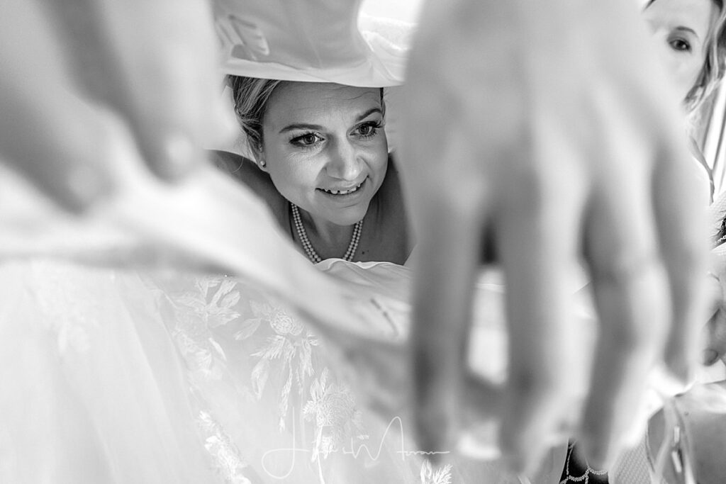 Bride getting into her wedding dress
